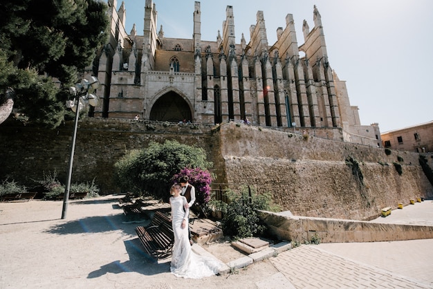 Foto la novia y el novio caminan juntos en la ciudad