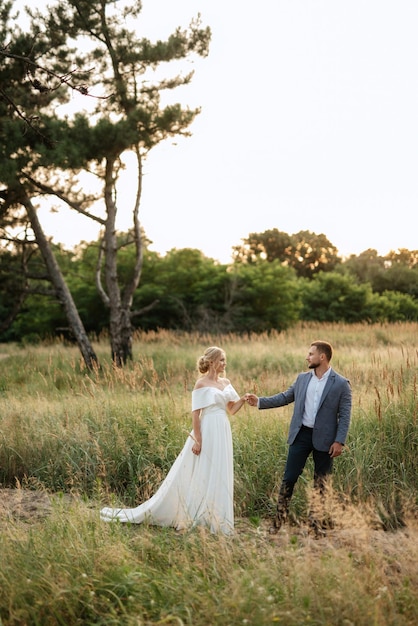 La novia y el novio en un paseo por el bosque