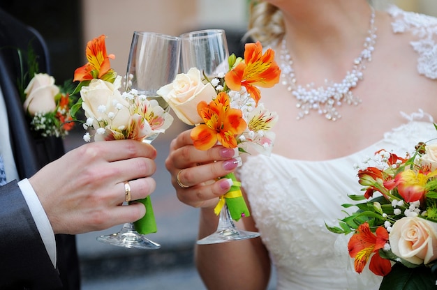 La novia y el novio sostienen copas de champán