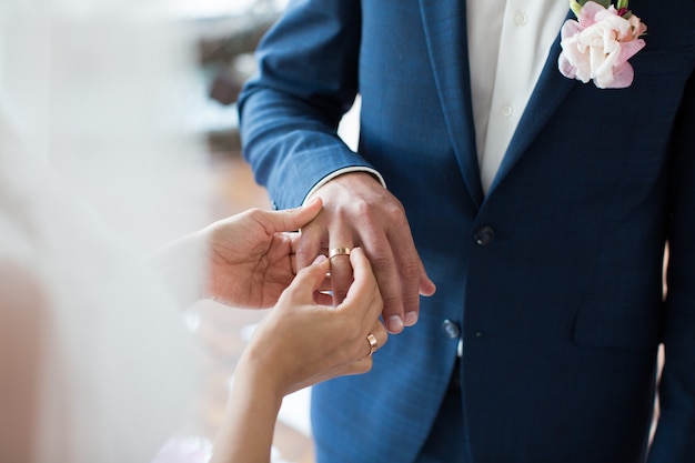 La novia pone el anillo en el dedo del novio