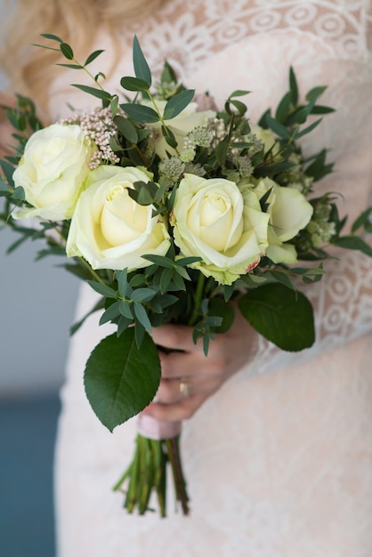 Novia sosteniendo un ramo de rosas de boda