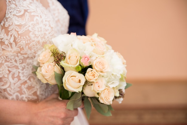 Foto la novia sostiene su hermoso ramo, flores de moda y otros artículos relacionados.