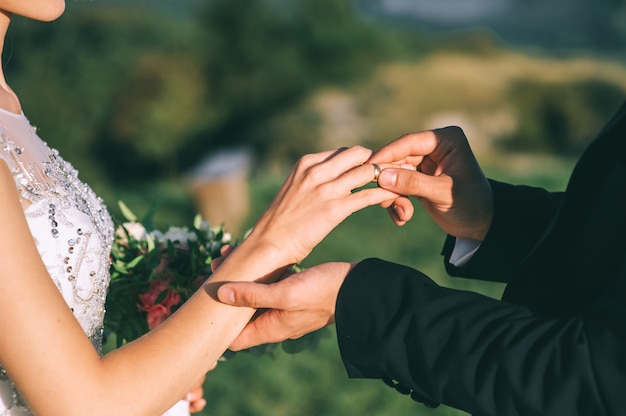 El novio lleva a la novia un anillo de bodas en la ceremonia.