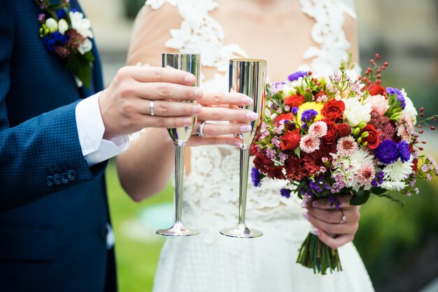 Novios con bouquet de bodas y champagne