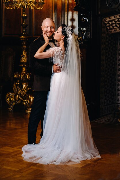 Novios elegantes en el interior del antiguo castillo de la ciudad de Nesvizh