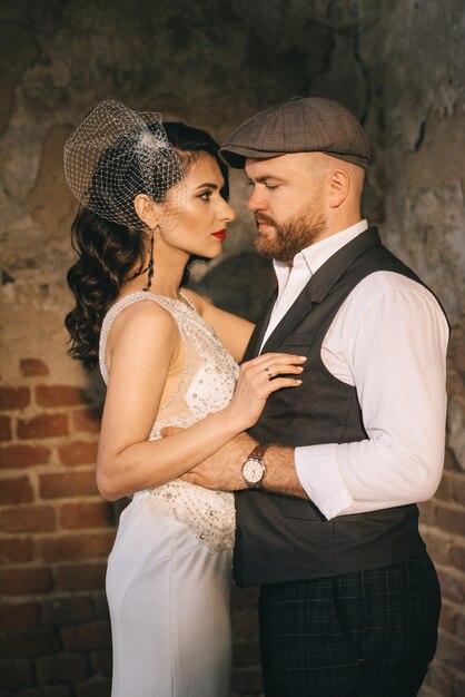 Novios retro dentro de la vieja iglesia en el rayo de sol