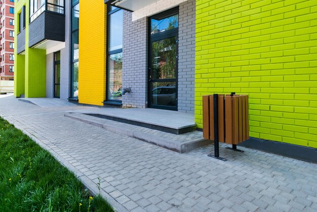 Novo edifício residencial de vários andares de tijolos coloridos no fundo de um céu azul com um brilho de sol