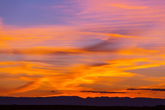 Nubes de tormenta inusuales al atardecer. Colores rojo y naranja brillantes del cielo. Adecuado para fondo.