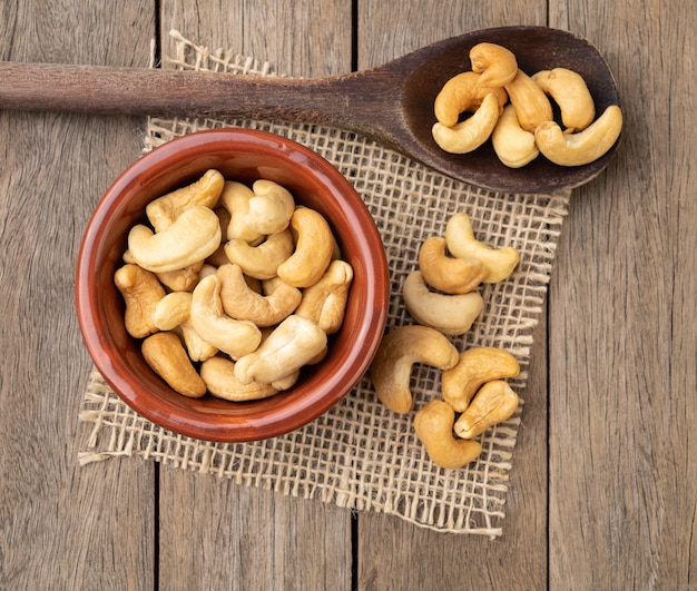 Nueces de cajú en un recipiente sobre una mesa de madera