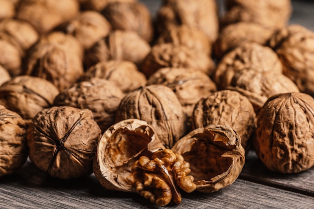 Nueces enteras y abiertas con grano de nuez en una mesa de madera