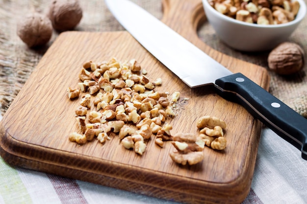 Foto nueces picadas en tabla de cortar de madera