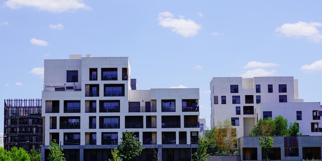 Nuevo edificio de línea de fachada blanca moderna con balcón y terraza en cielo azul