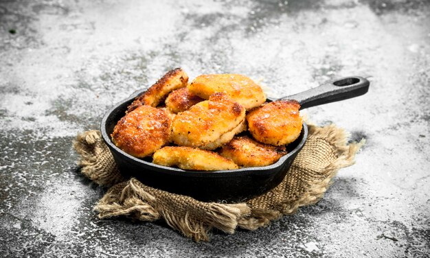 Nuggets de frango em uma frigideira.