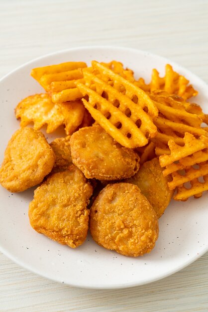 nuggets de frango frito com batatas fritas no prato