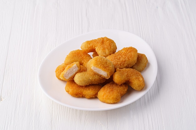 Nuggets de pollo en una placa blanca.