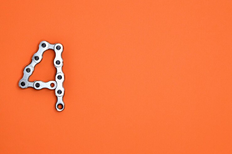 Foto number 4 formed from a metallic chain on an orange background