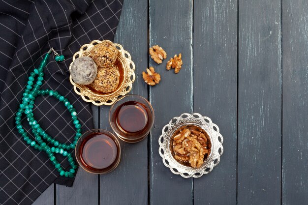 Nussbällchen-Nachtisch serviert mit Kaffee auf dunklem Holztisch, Draufsicht