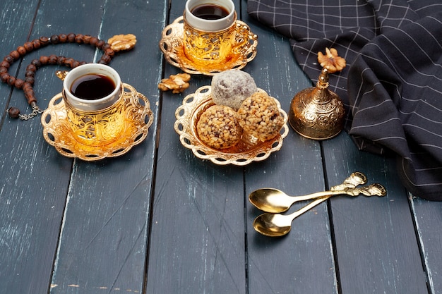 Nussbällchen-Nachtisch serviert mit Kaffee auf dunklem Holztisch, Draufsicht