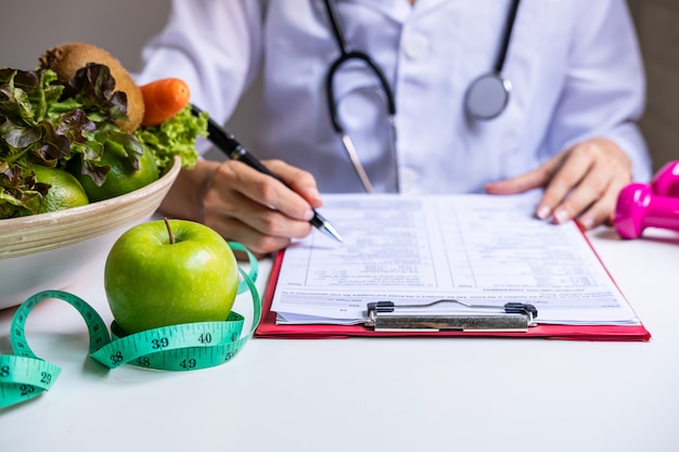 Foto nutricionista con trabajo saludable de frutas, verduras y cinta métrica, concepto adecuado de nutrición y dieta