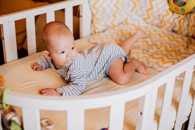 O bebê está deitado em um berço na barriga.