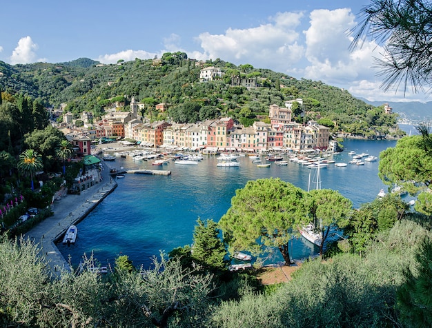 O belo panorama de portofino com casas coloridas, barcos e iate em little bay harbor. ligúria, itália