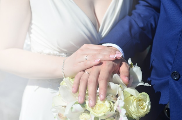 O casal recém-casado está segurando um lindo buquê de casamento