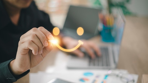 Foto o consumidor respondeu a pesquisa de forma conceitual. o cliente cria um símbolo sorridente de rosto feliz usando uma caneta digital. a noção de felicidade do cliente e experiência de serviço.