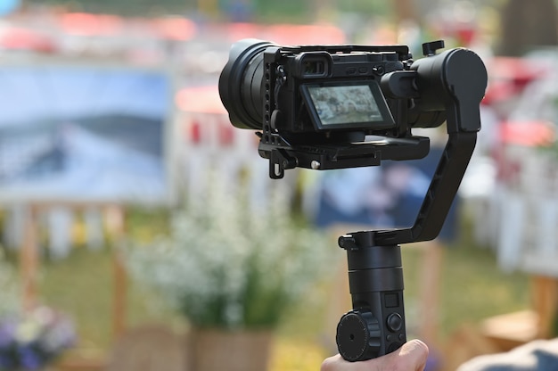 O fotógrafo Operador de câmera de vídeo em estabilizadores trabalhando com seu equipamento para prestar muita atenção para tirar uma foto.