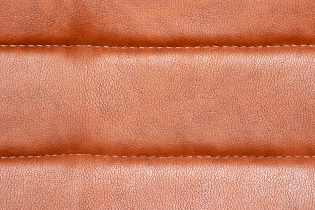 O fundo do estofamento de couro da cadeira é closeup Textura de estofamento de couro