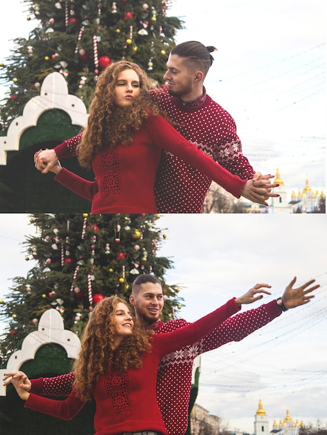 O garoto e a garota de camisola vermelha estão sorrindo alegremente para a árvore de natal.