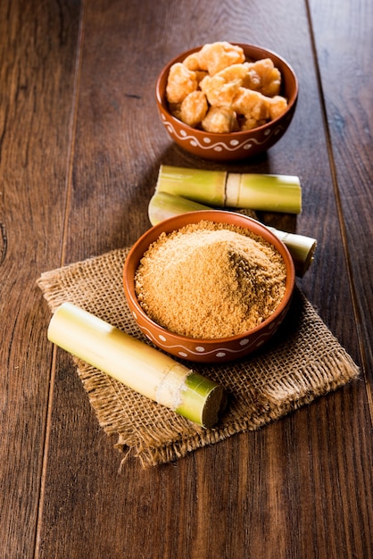 Foto o gur orgânico ou jaggery em pó é o açúcar não refinado obtido do caldo concentrado da cana-de-açúcar. servido em uma tigela. foco seletivo