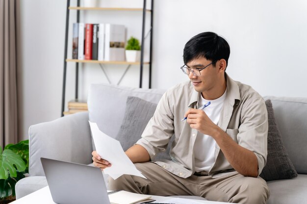 Foto o homem está a calcular o imposto anual com uma calculadora e a preencher o formulário da declaração do imposto de renda individual