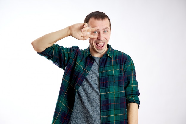 O homem sorri, um rosto feliz e contente. Um cara de camisa posando