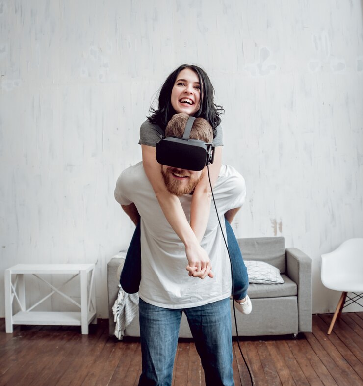 Foto o jovem com a namorada jogando jogos com óculos de realidade virtual