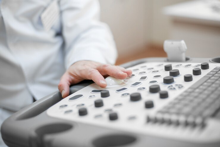 O médico mantém um ultra-som no paciente, uma mão de perto