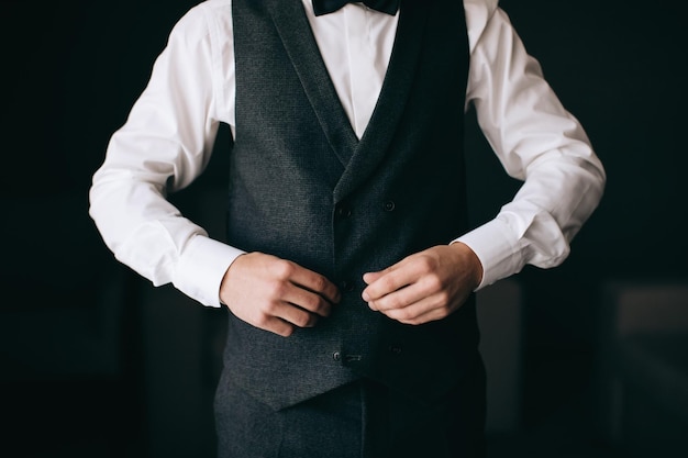 O noivo veste uma camisa no hotel Manhã de casamento