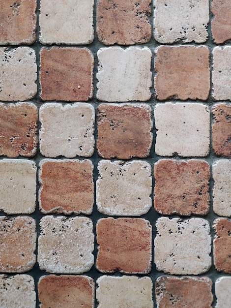 O piso de pedra é feito de ladrilhos de duas cores em um padrão quadriculado vista de cima