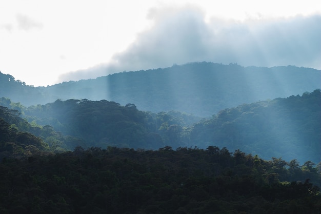 Foto o sol brilha através das nuvens. linda nas montanhas.