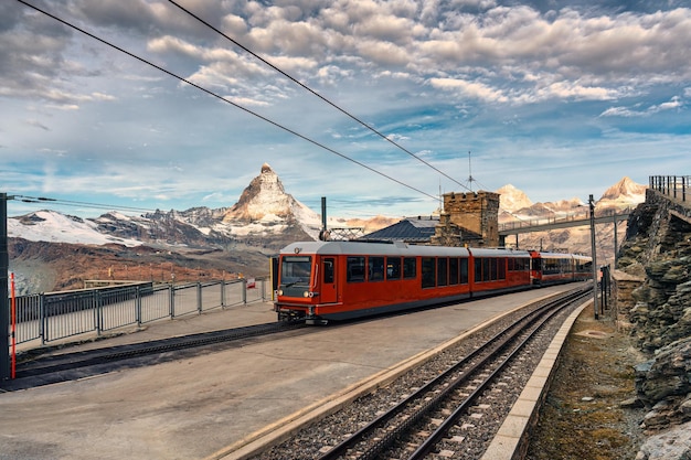 O trem elétrico com a montanha Matterhorn no cume na estação de Gornergrat