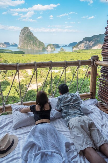 O viajante feliz do casal desfruta do ponto de vista da baía de Phang Nga Turistas relaxando no resort tropical em Samet Nang She perto de Phuket, no sul da Tailândia, conceito de viagem e férias de verão no sudeste da Ásia