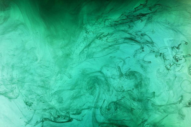 Foto océano azul-verde abstracto, pintura en el fondo del agua. remolino de salpicaduras y olas en movimiento. papel tapiz de arte fluido, colores vibrantes líquidos