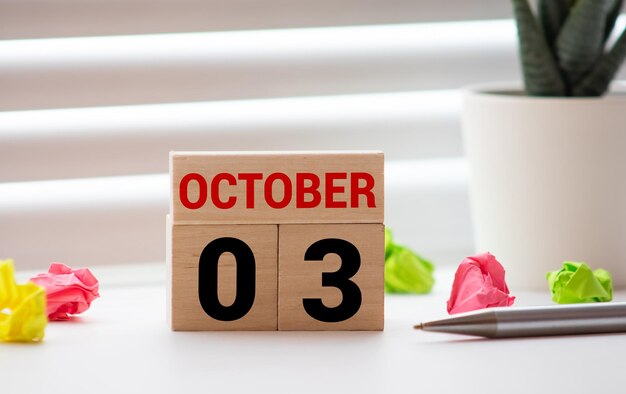 Foto october 3rd image of october 3 wooden color calendar on white canvas background empty space for text