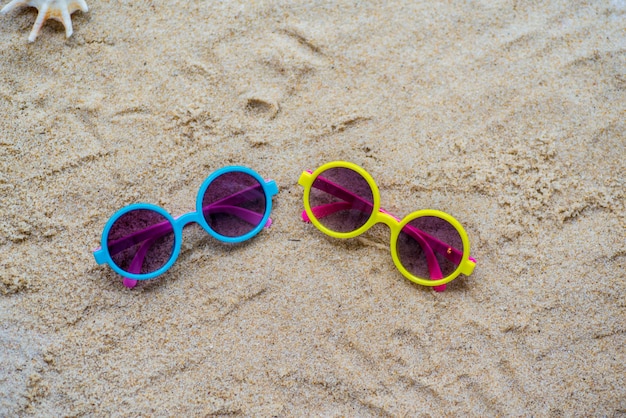 Óculos de sol na areia na praia