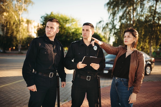 Foto oficiales de policía que escuchan el testimonio del conductor