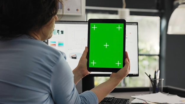 Foto oficinista examina el diseño de pantalla verde