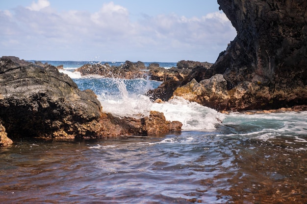 Olas del mar y roca en la playa.