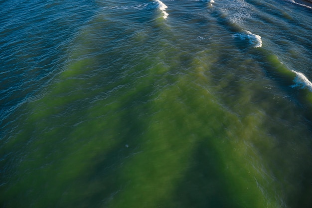 Olas de vista aérea en la playa de arena. Olas del mar en la hermosa playa vista aérea drone 4k tiro.