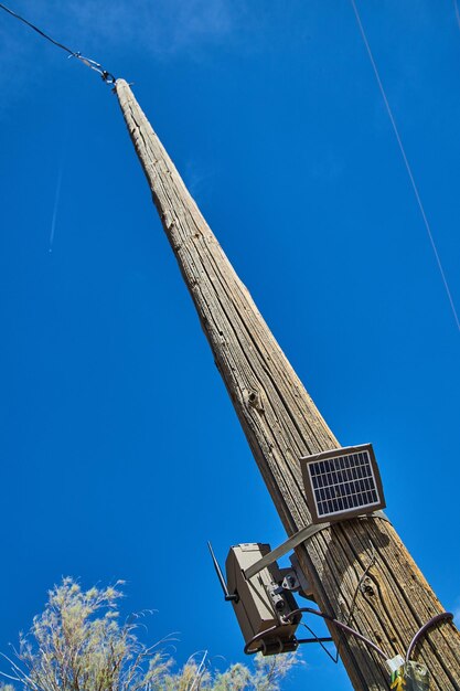 Olhando para o poste de telefone com câmera e painel solar