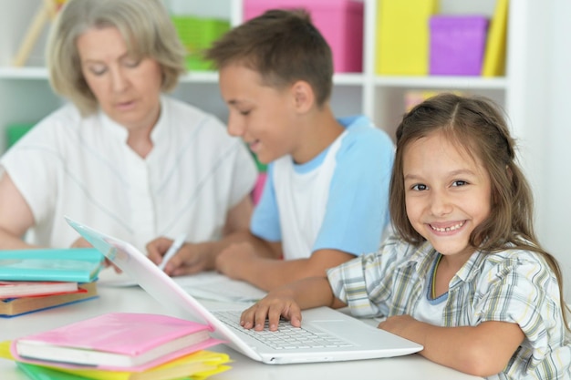 Oma mit Enkelkindern, die Hausaufgaben machen