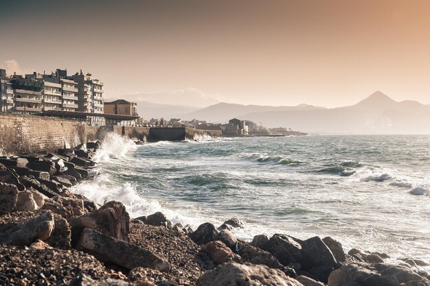 Ondas à beira-mar ao pôr do sol. Heraklion, ilha de Creta, Grécia. Foco seletivo, filtro vintage criativo